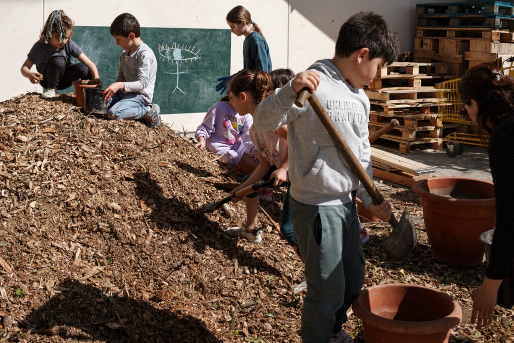 Familias y alumnado trabajando en la transformación del patio.